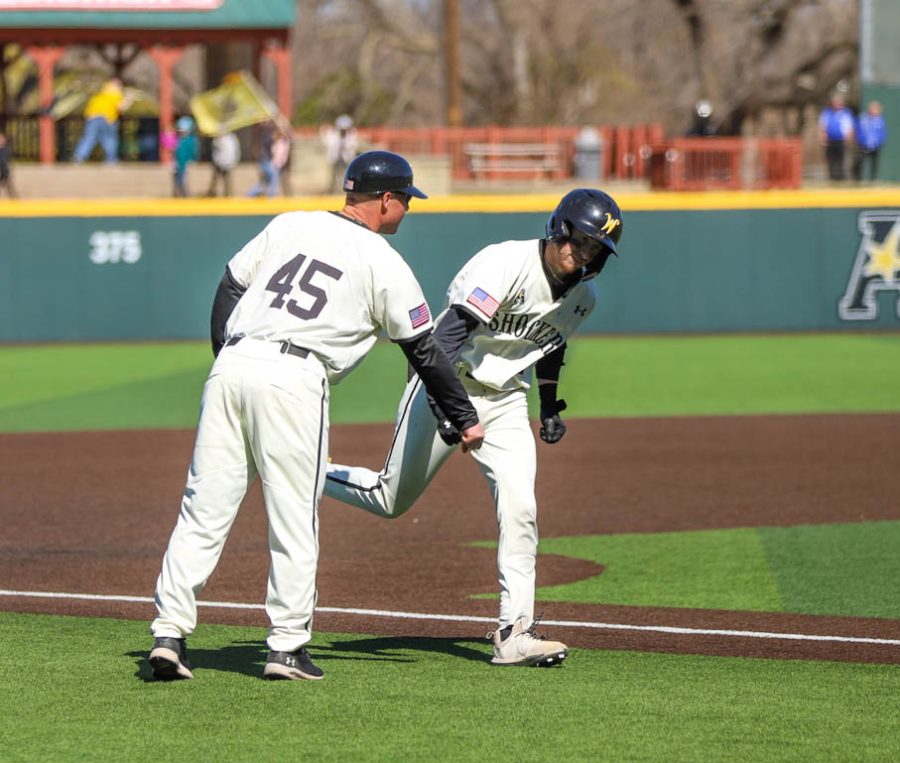Andrew Stewart celebrates with assistant coach Mike Sirianni after his first career home run during WSUs game against South Dakota State on March 13 inside Eck Stadium.