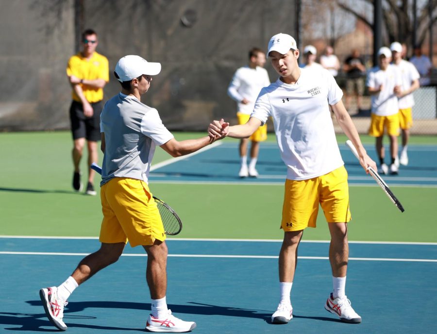 Nicolas Acevedo celebrates with Jackie Lin after a point during the match against Omaha on March 3 at the Coleman Tennis Complex. 