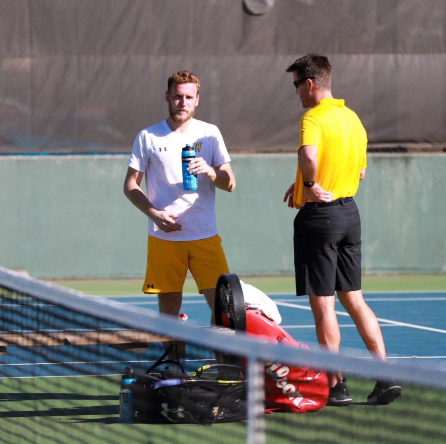 Kristof Minarik talks with Head Coach Danny Bryan after his match against Omaha on March 3 at the Coleman Tennis Complex. 
