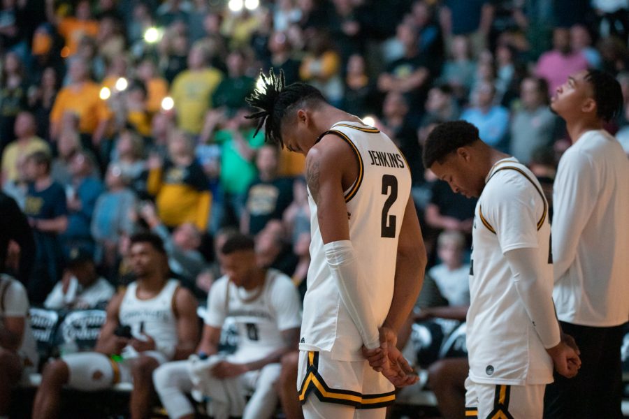 Freshman+Chaunce+Jenkins+and+junior+Qua+Grant+bows+their+heads+before+the+starting+five+are+announced+in+Koch+Arena.