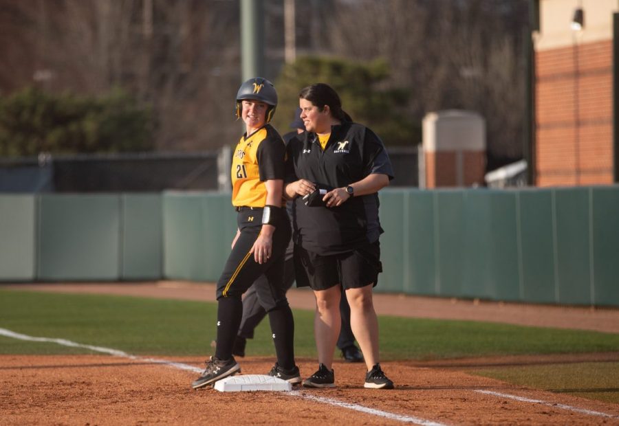 After making it to first base, freshman Krystin Nelson talks to volunteer assistant coach Mary Stephens inside the OU Softball Complex on March 29.