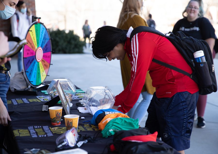 Wichita State student enters into the CAPPS raffle during Student health CAPPS Tipsy Turvy booth on March 1.