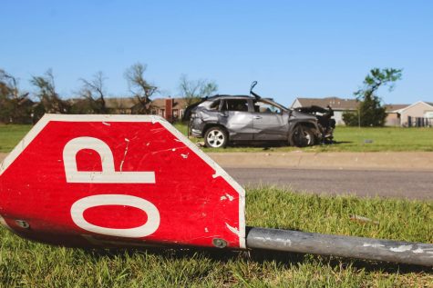 A damaged stop sign and car in front of Prairie Creek Elementary school after last nights tornado at Andover, Kansas.