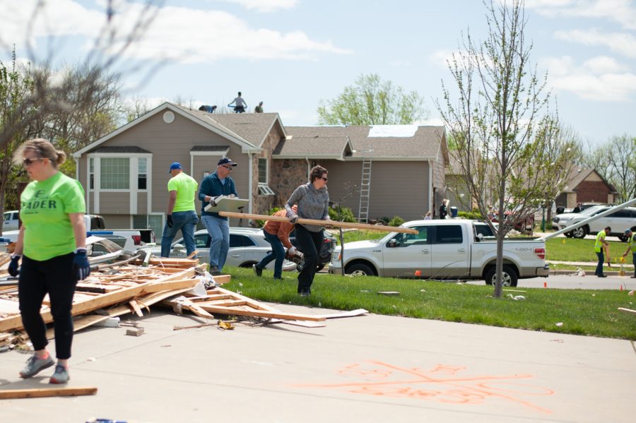 Andover neighborhood residents clean up much of the debris created by the tornado that swept through the town and surrounding areas the previous night.
