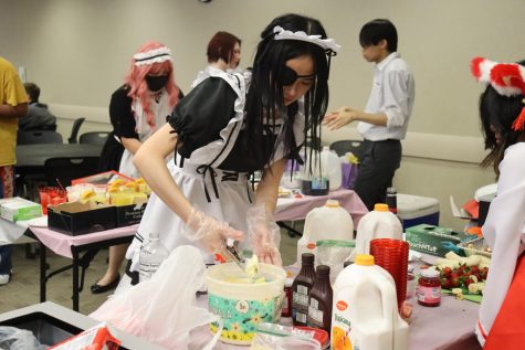 Society of Cosplayers members prepare for their Maid Café event, serving pancakes, ice cream and stir fry. 
