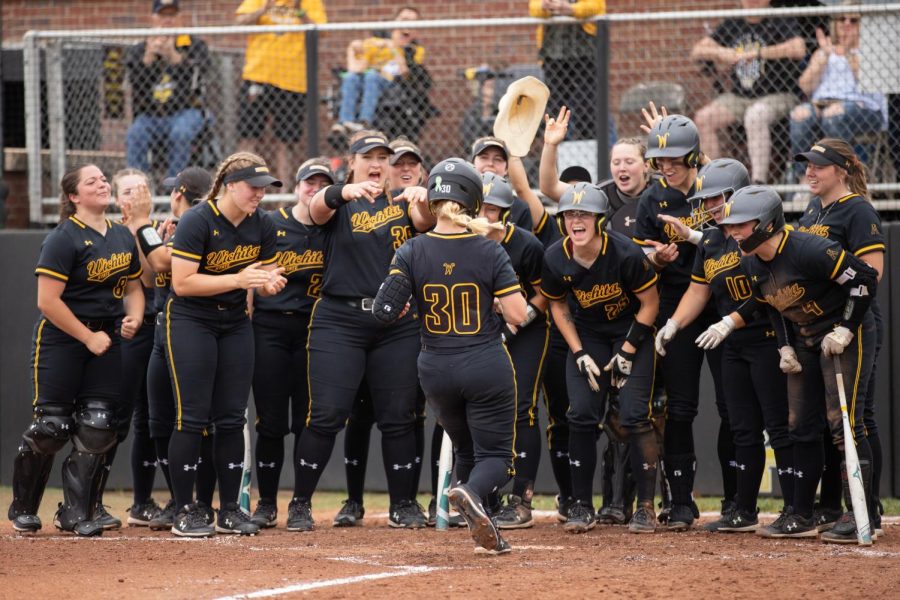 Sophomore+Addison+Barnard+is+greeted+by+her+teammates+during+WSUs+game+against+Memphis+on+April+23+at+Wilkins+Stadium.