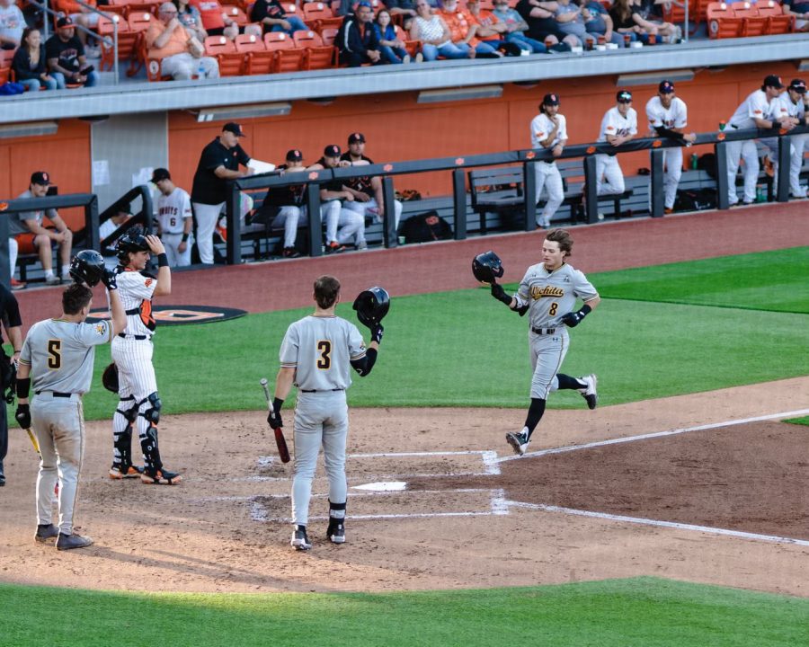Brock Rodden celebrates with his Shocker teammates after hitting a solo home run against Oklahoma State on April 12 at OBrate Stadium.