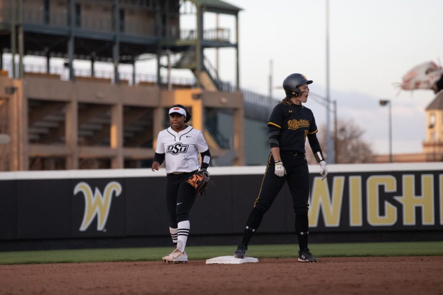 Senior Neleigh Herring cheers for freshman Krystin Nelson after advancing her to second base. Herring was the only Shocker to earn a run against OSU on Apr. 6 in Wilkins Stadium.