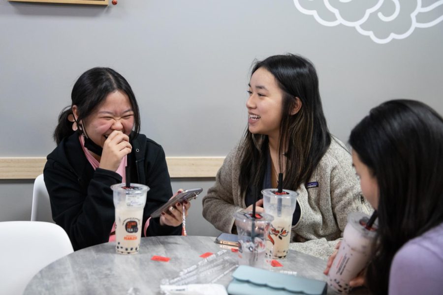 Biology majors Ashley Dinh and Cam Ta laugh together during the Boba Social on April 8. The event was open to all students and allowed them a free boba drink.
