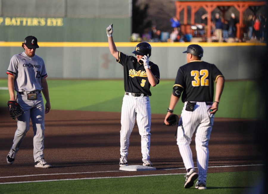 Freshman Xavier Casserilla motions to the Shocker dugout after a single during WSUs game against Cincinnati on April 14 at Eck Stadium.