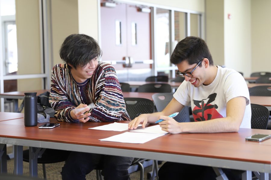 Koki Murakami (L) and Alex Limon (R) write Haikus at a Japanese Culture Association meeting on April 15, 2022 at the Rhatigan Student Center.