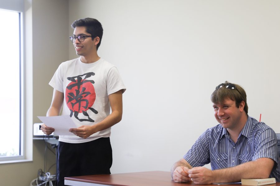 Alex Limon (L), reads a Haiku he wrote out loud at a Japanese Culture Association meeting, as Association President Joshua Keese (R) listens , April 15, 2022 at the Rhatigan Studnet Center.