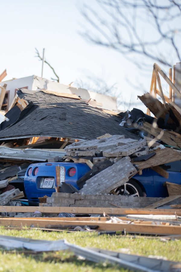 Debris from a tornado in Andover Kansa piles ontop of a car near Stonewood Street. Local firefighter and city workers came together to help residents search for belongings on Apr. 30.