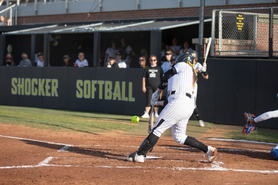 Junior Zoe Jones goes to bat the ball during the game against KU on April 20 in Wilkins Stadium.