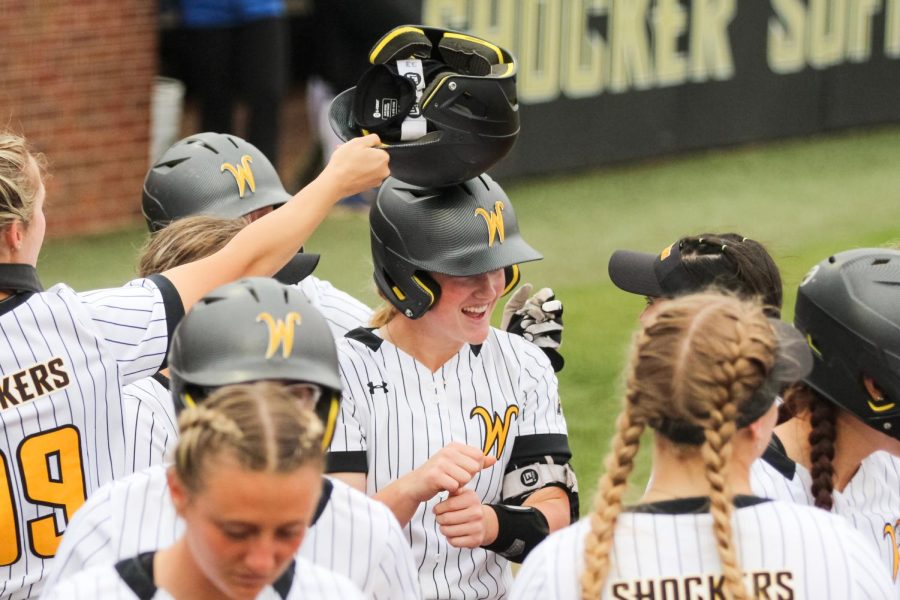 The+WSU+Softball+team+celebrates+after+Sophomore+Addison+Barnard+hits+a+home+run.+The+softball+team+played+against+Memphis+on+April+22.
