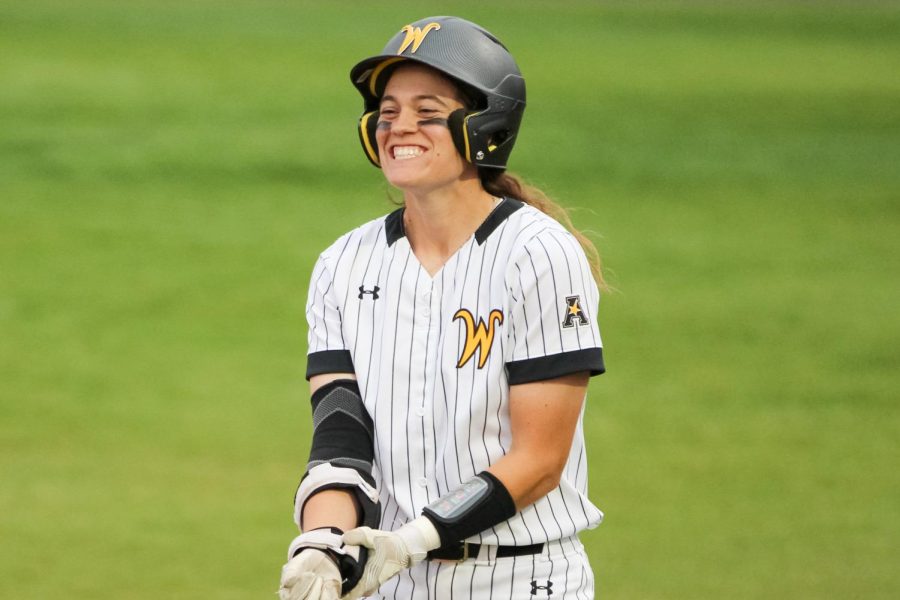 Senior Neleigh Herring smiles to her team aftering winning a run for the Shockers during the game against Memphis on April 22.