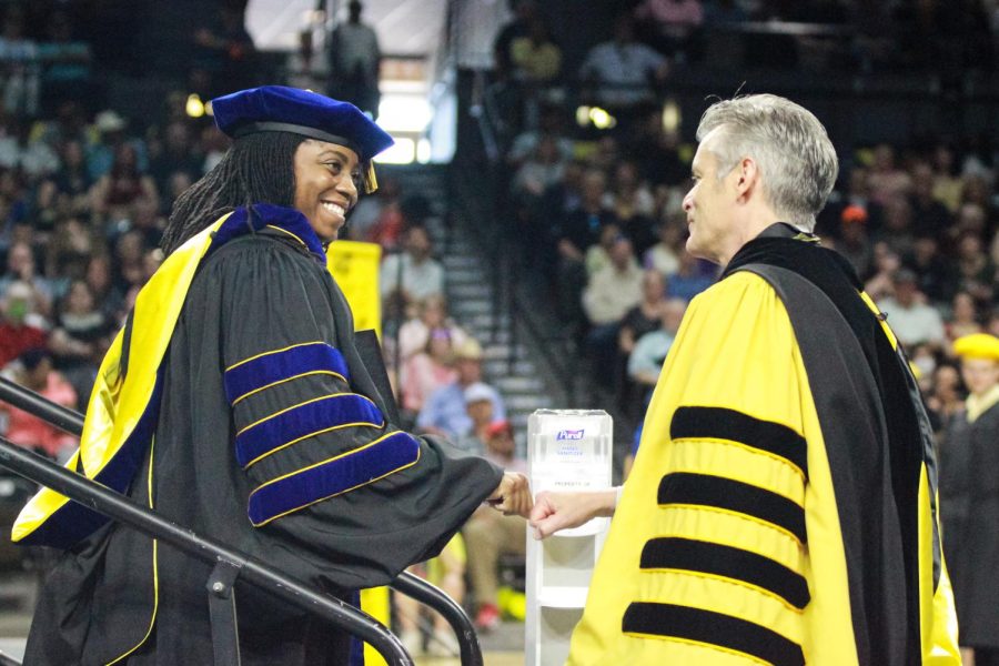 A graduate fist bumps President Muma at the Spring Commencement Ceremony on May 14, 2022.