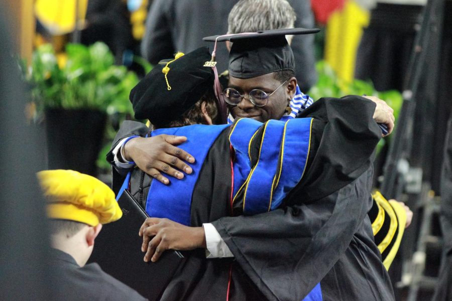 Spring 2022 graduate hugs a professor after receiving their diploma.
