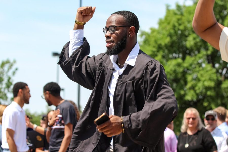 Graduate performs and dance outside of Charles Koch Arena on May 14, 2022 after the Spring Commencement Ceremony.