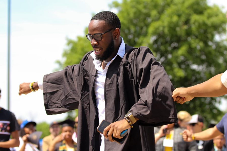 Graduate performs and dance outside of Charles Koch Arena on May 14, 2022 after the Spring Commencement Ceremony.