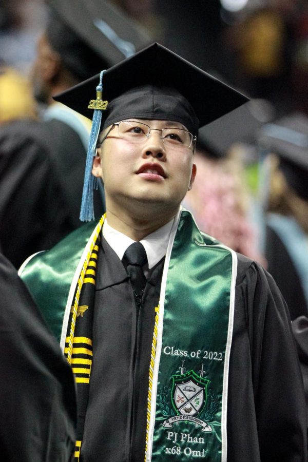 Graduate observes the crowd at Charles Koch Arena on May 14, 2022.