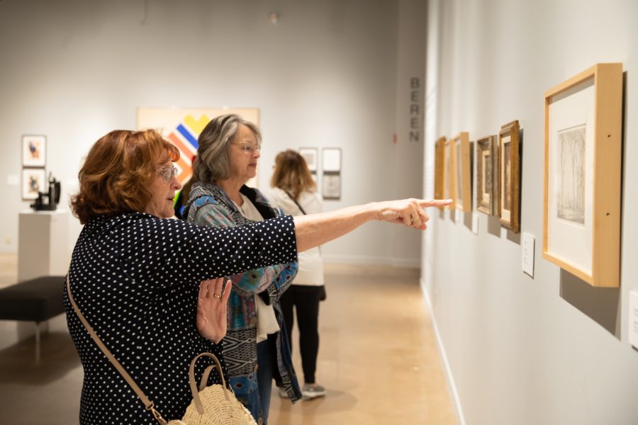 Musuem-goers examine the art on display inside the Ulrich during the Summer 2022 Exhibition Opening Celebration.
