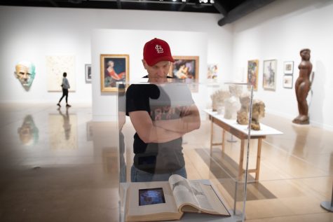 A museum-goer examines the work on display in the Deep Dive exhibition room. The exhibition featured selections from the museums permanent collection.