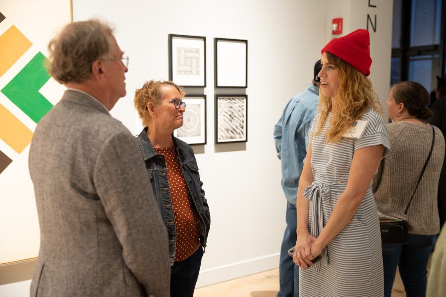 Musuem-goers speak to Ulrich Alliance member Emily Scott. The Ulrich Alliance was a volunteer group dedicated to promoting the arts.