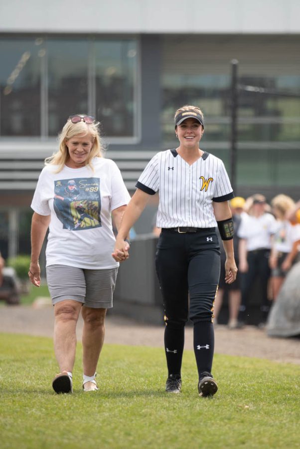 Senior Erin McDonald walks with her mother, Michele, on Senior Day on May 8 at Wilkins Stadium.
