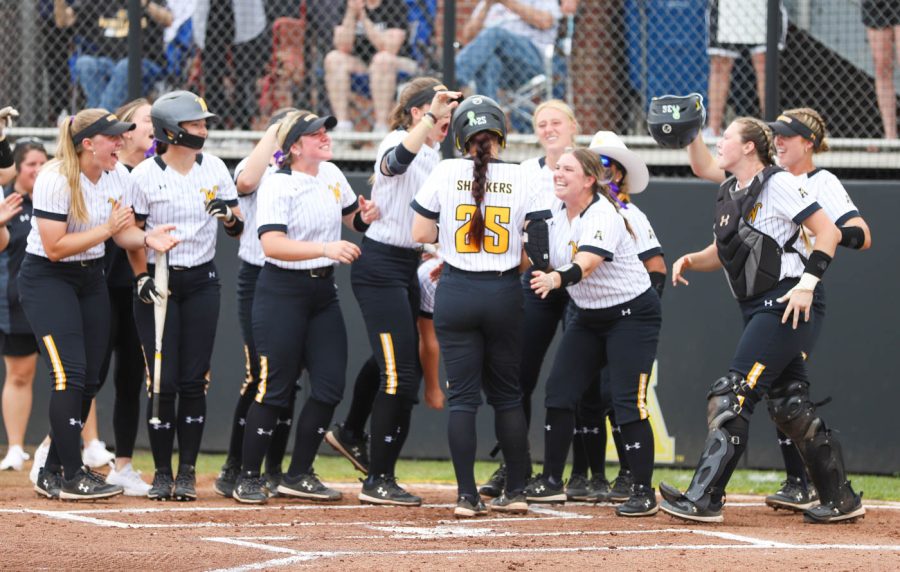 Junior Sydney McKinney is greeted by her teammates after hitting a home run in the first inning of WSUs game against UCF on May 8 at Wilkins Stadium.