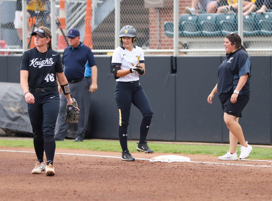 Sophomore Lauren Lucas smiles after reaching first base during WSUs game against UCF on May 8 at Wilkins Stadium.