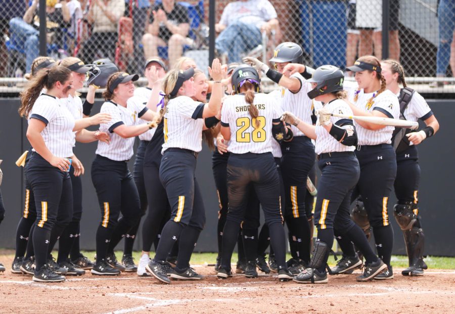 Sophomore Lauren Lucas celebrates with her teammates after hitting a homer during WSUs game against UCF on May 8 at Wilkins Stadium.