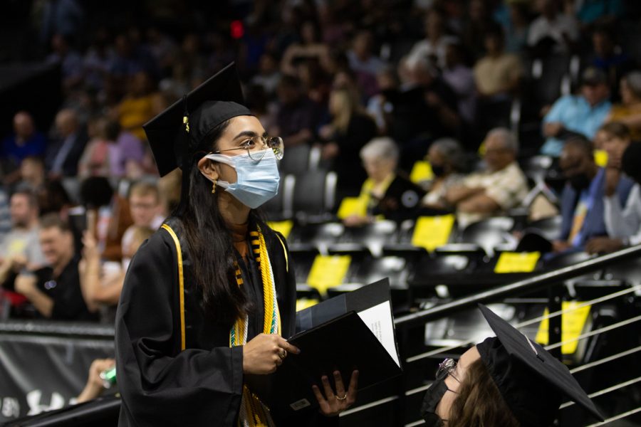Former Student Body President Rija Khan looks around Koch Arena before the 2022 Spring Commencement Ceremony.