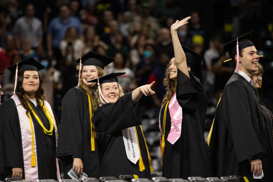 Graduates walk into Koch Arena and find friends and family in the crowd during the first 2022 Spring Commencement Ceremony.