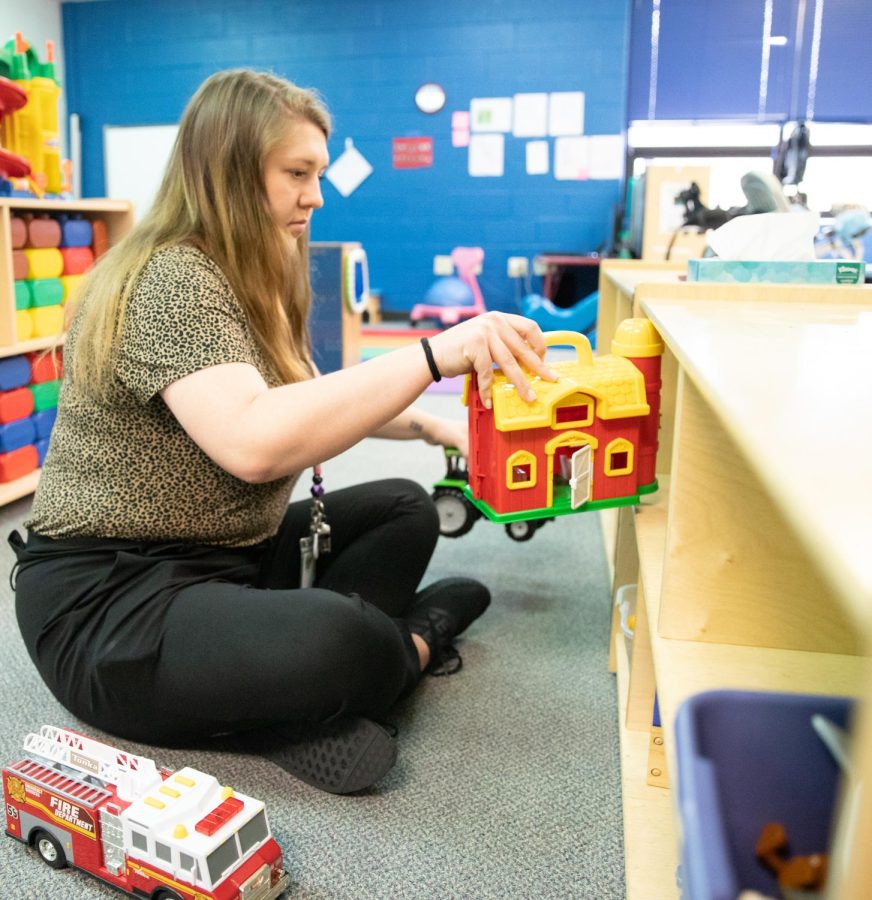 Alexandra Gilmore puts away toys at the Little Early Childhood Center.  She wants to work with kids in special education.