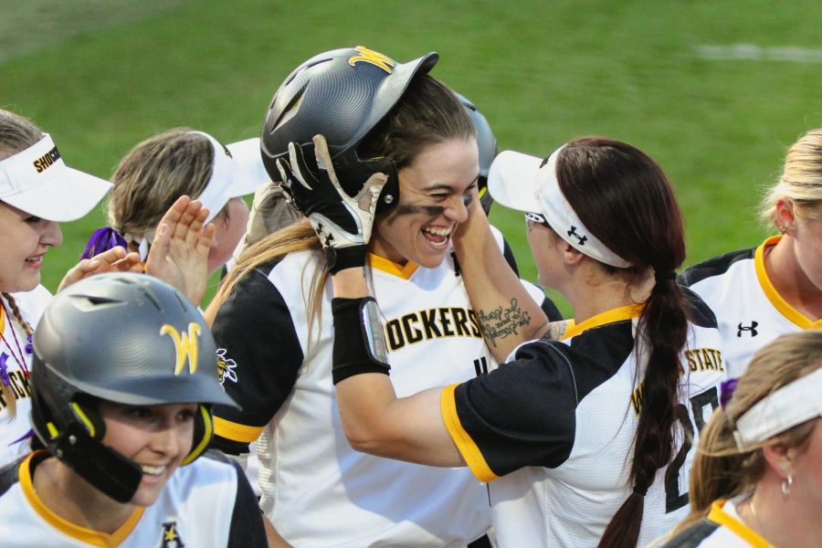 Neleigh Herring celebrates with Sydney McKinney after Herrings grand slam in the fourth inning during WSUs game against UCF on May 6 at Wilkins Stadium.