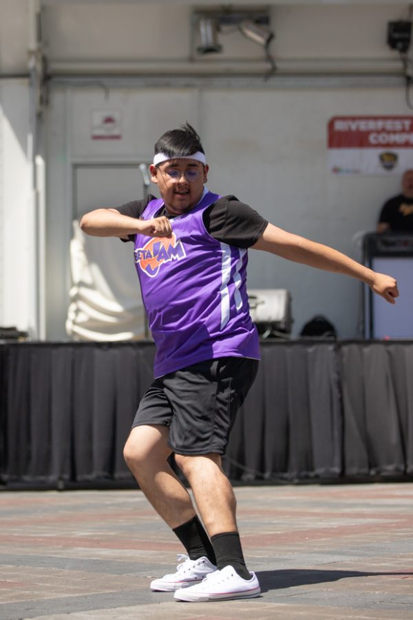 A Sigma Lambda Beta member dance during the Stroll Off Competition during Riverfest on June 5.