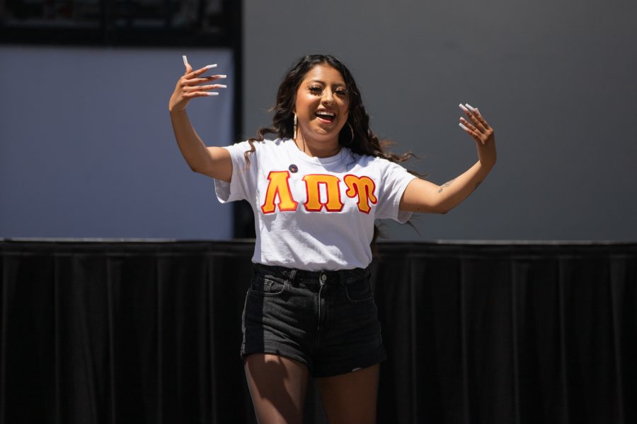 A Lambda Pi Upsilon member hypes up the crowd at the Stroll Off Compeition during Riverfest.