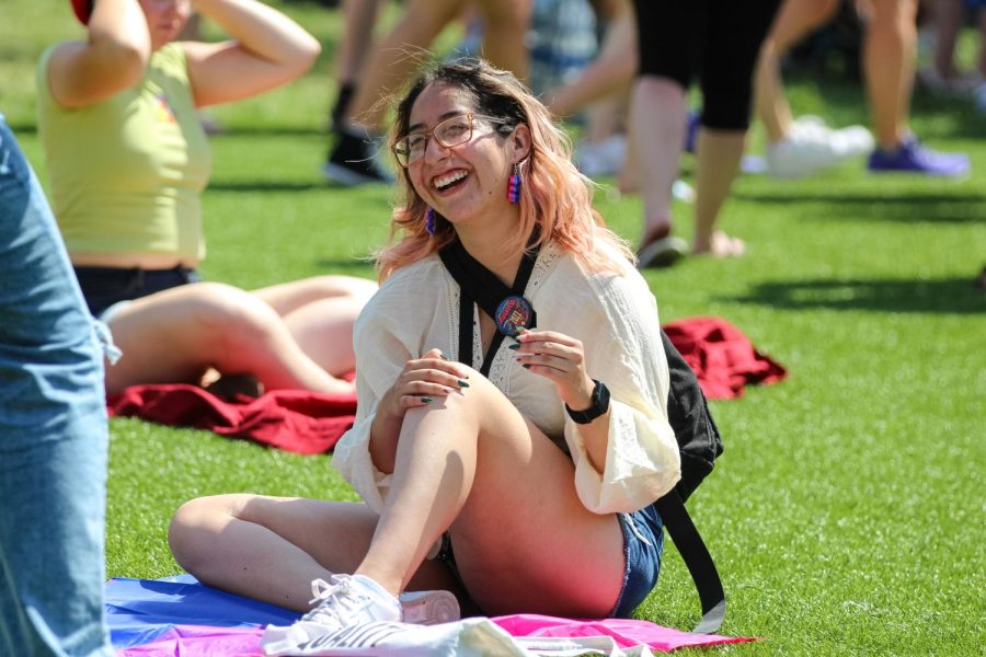 Event goer takes a photo with their bisexual pride flag at Naftzger park. The Family Picnic event was held on June 25, 2022.