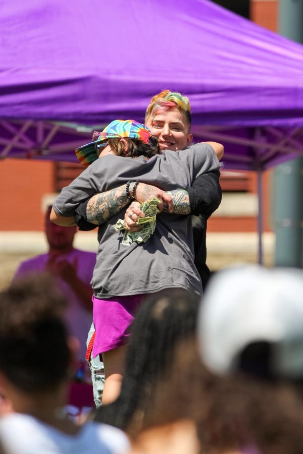 Ladiesman Ronee Demornay hugs event goer at the Family Picnic on June 25, 2022.