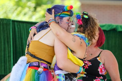 A couple kiss after sharing their marriage vows at the Wichita Pride Family Picnic. The celebration was held at Naftzger Park on June 25, 2022.