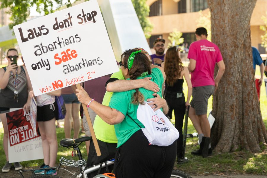 Two friends hug after the march on July 9 in downtown Wichita.