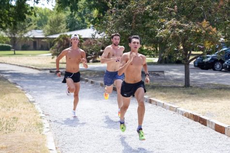 Freshman Jacob Meyers, Riley Vandaveer and sophomore Erik Enriquez practicing at Riverside Park in Wichita on Aug. 23. For their first meet of the 2022 season, both teams will travel to Augusta to compete at the JK Gold Classic. 
