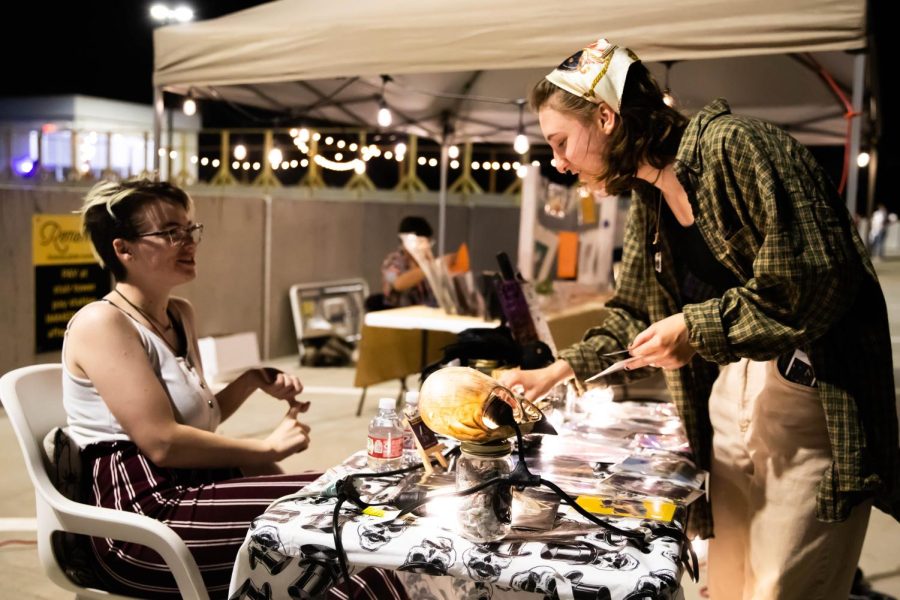 WSU student Sophia Hart buying digital prints at the 2nd Annual NXT LVL Garage party. The event was hosted by the Office of Diversity and Inclusion at the public parking garage on August 19, 2022.