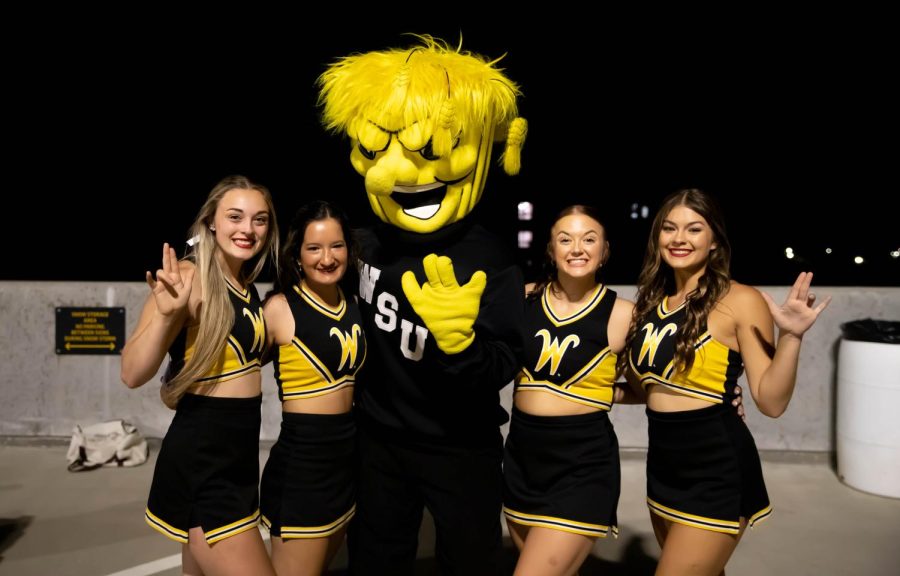 Spirit squad members taking pictures with WuShock at the 2nd Annual NXT LVL Garage party. The event was hosted by the Office of Diversity and Inclusion at the public parking garage on August 19, 2022.