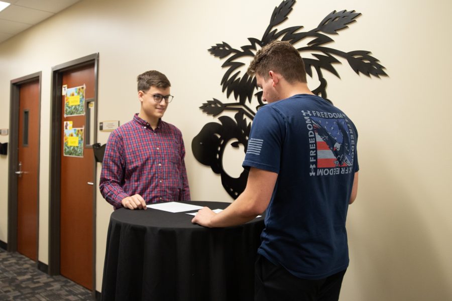 SGA engineering senator Zane Berry signs former Vice President Mitchell Adamson into the presidents office after resignation of former president Olivia Gallegos.