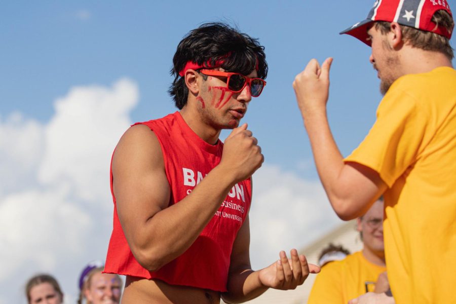 Freshman Jayden Khakh attempts to defeat the College of Liberal Arts and Science in a rock paper scissors competition at the Clash of Colleges. LAS defeated the School of Business on Aug. 26 at Cessna Stadium.