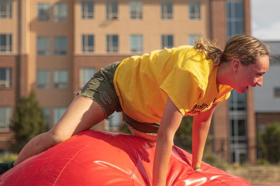 A member of the College of Liberal Arts and Science crosses the inflatables on Aug. 26 during the Clash of Colleges. The inflatable course was designed to replicate the Wipe Out course.