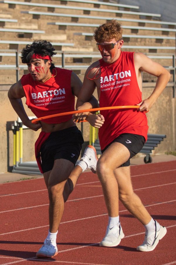 Freshmen Jayden Khakh and Spencer Blaine running the hula hoop leg of the relay race during the Clash of Colleges.