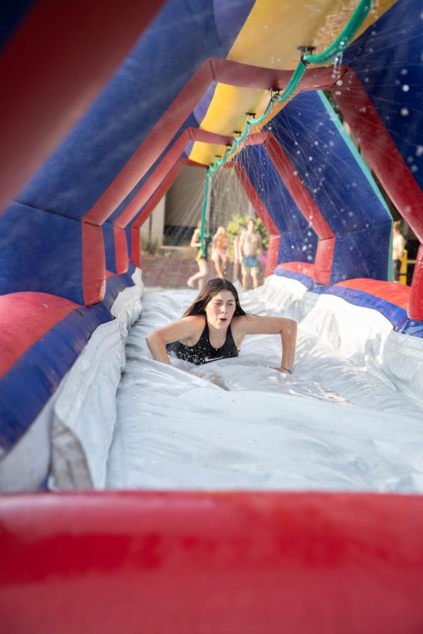 WSU student slips through giant water slip-n-slide. The event was hosted by SAC at RSCs east courtyard on Aug 25.